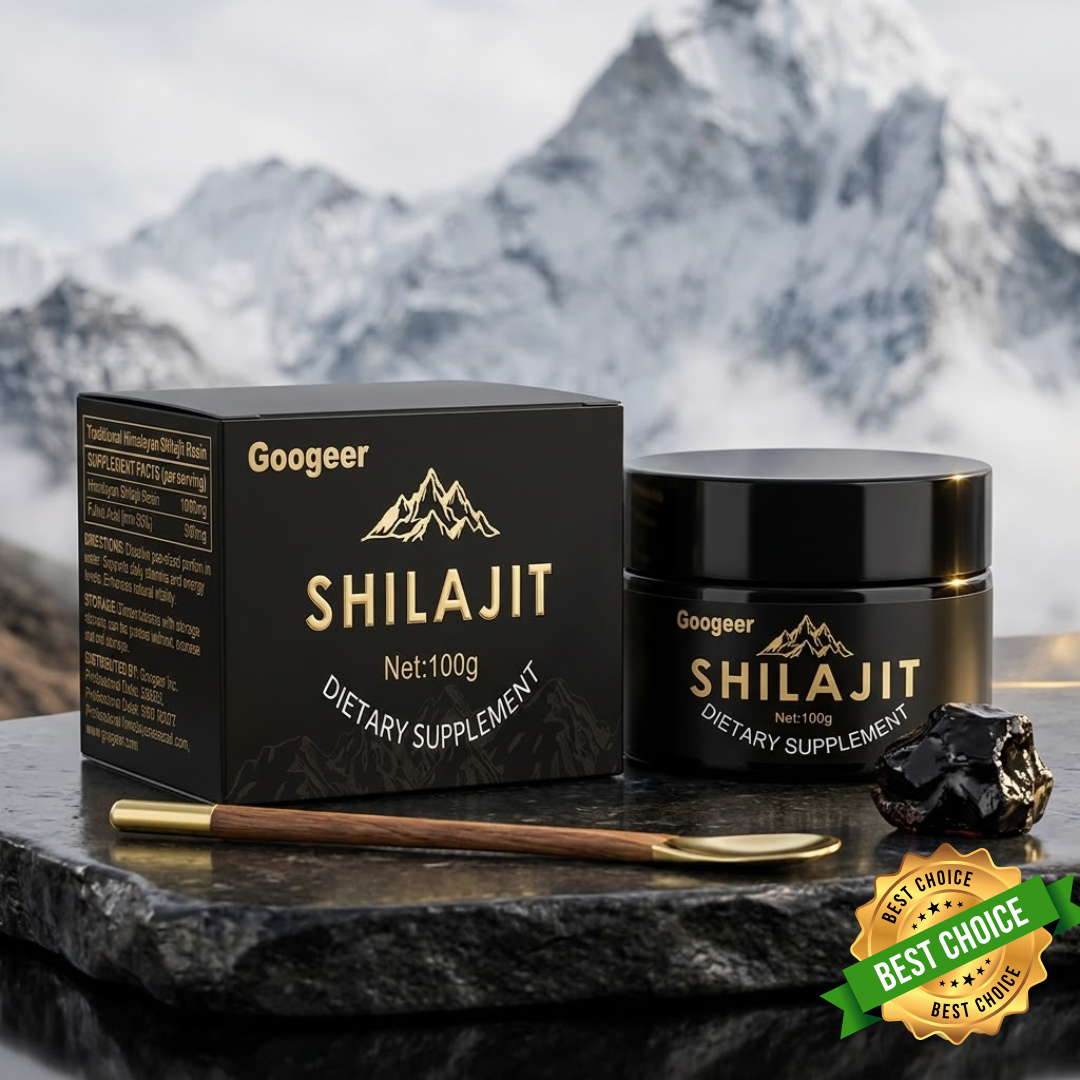 Googeer Shilajit dietary supplement set featuring a black box, black jar, a wooden spoon with gold detailing, and a raw black rock, displayed on a dark stone surface with a blurred mountain background.