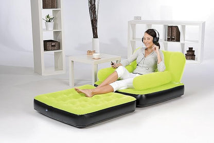 Woman sitting on a green inflatable sofa in a minimalistic room.