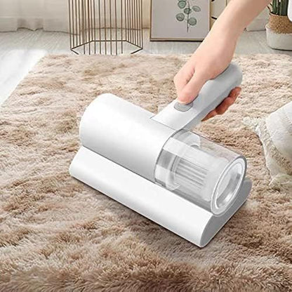 Hand using a handheld vacuum cleaner on a carpeted floor